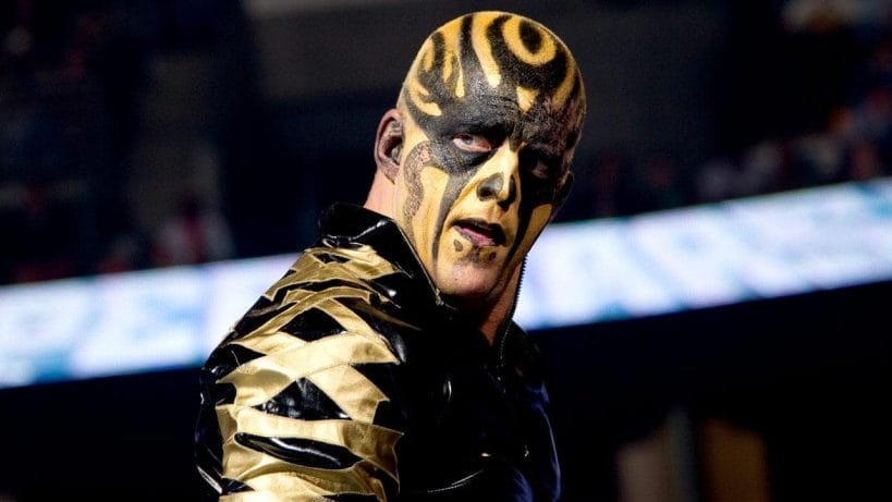 Dustin Rhodes | 4 Stories Revealing the Man Behind the Paint Dustin Rhodes as Goldust in black and gold face paint and leather jacket
