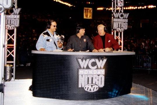 The announcers at the desk of WCW Monday Night Nitro