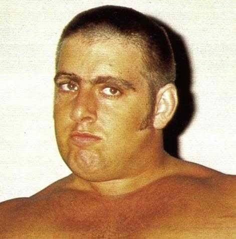 A young Ric Flair with dark brown hair in a crew cut
