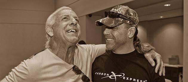 Ric Flair with his arm around Shawn Michaels shoulder sharing a laugh