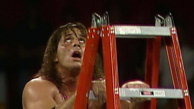 Bret Hart climbing a red ladder