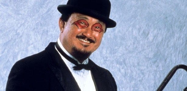 Mr. Fuji in his black bowler hat and a black tuxedo with red and black eye makeup on