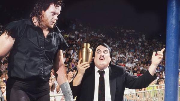 The Undertaker heading into the ring with Paul Bearer holding an urn