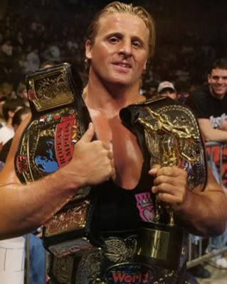 Owen Hart won every major championship in the WWF, except for the WWF Championship here is is shown holding 3 title belts