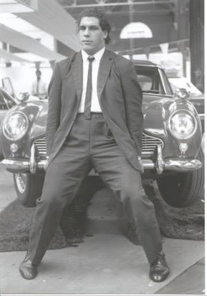 Andre the Giant in a suit picking up the front of a car when he was younger