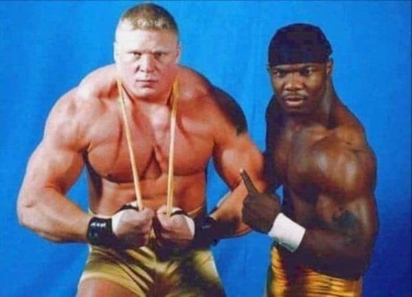 Brock Lesnar posing in a sling with college friend Shelton Benjamin