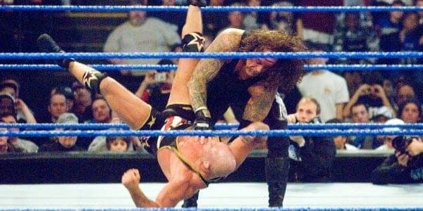 In the ring The Undertaker chokes out Kurt Angle