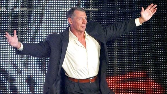 WWE CEO Vince McMahon on Stage with his arms stretched wide