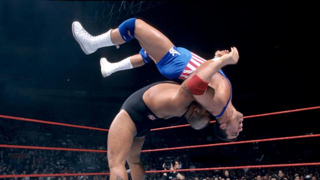 Tazz in the ring flipping Kurt Angle into the air