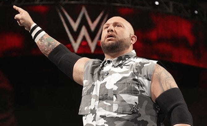 Bubba Ray in a grey camo shirt with no sleeves holding up the #1 sign at a WWE Event