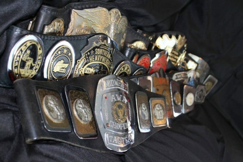 A selection of Reggie Parks-made title belts for various promotions, including the WWE, AWA, Memphis, Knoxville, and World Class promotions