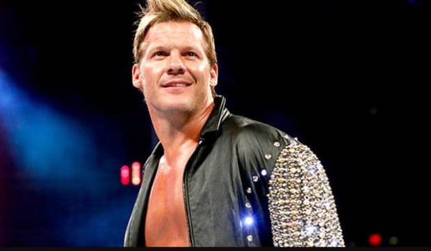 Chris Jericho smiling in a leather rhinestone studded sleeve jacket