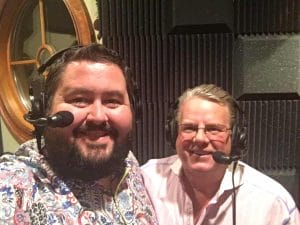 Conrad Thompson and Bruce Prichard working on the podcast with headsets on