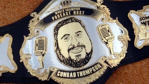 Wrestling Title Belt image World Class Host Conrad Thompson on it and 2 microphones