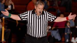 Wrestling Referee with whistle in his mouth and hands up