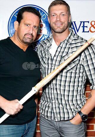 Respect in Wrestling TOMMY DREAMER and EDGE dressed in street clothes. Tommy's holding a piece of bamboo over Edge's chest
