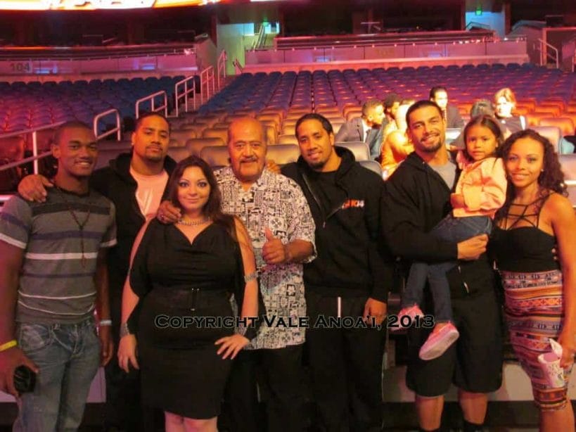 The Anoa'i wrestling family posing in a casual photo together in an empty arena