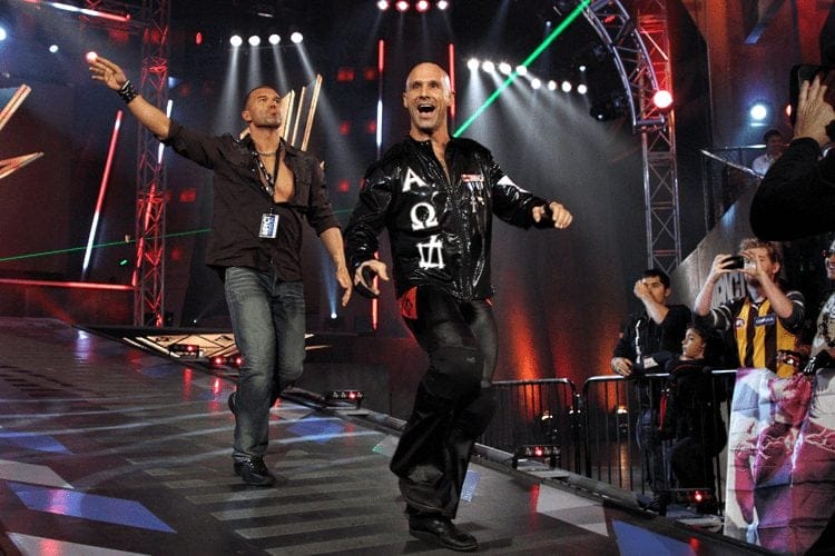 Frankie Kazarian and Christopher Daniels as part of Bad Influence enter on a stage to wrestling music "Devious" to laser lights