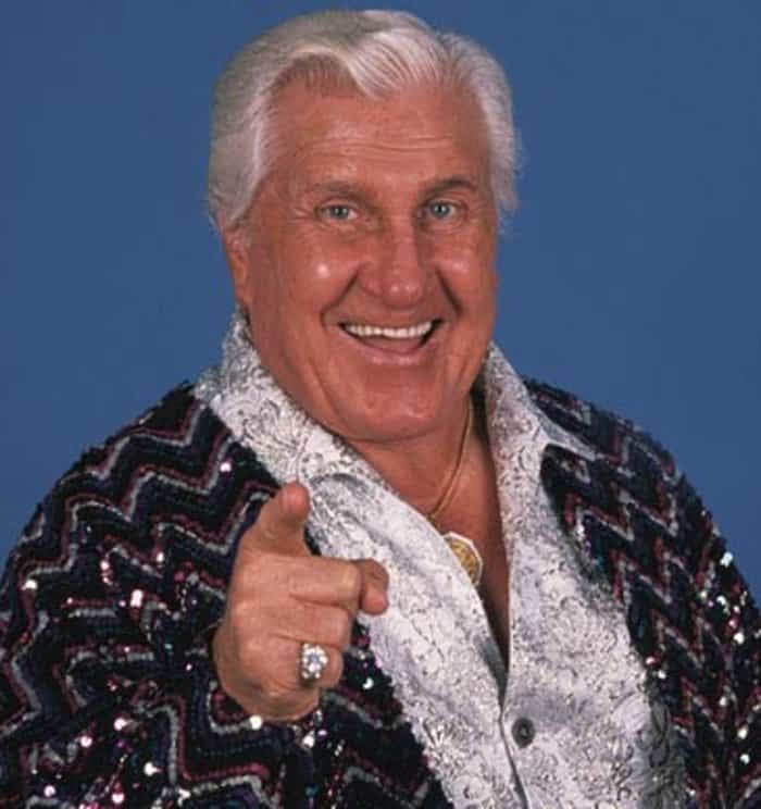 Classy Freddie Blassie on our top 10 wrestling managers list in a sequined jacket and paisley shirt pointing