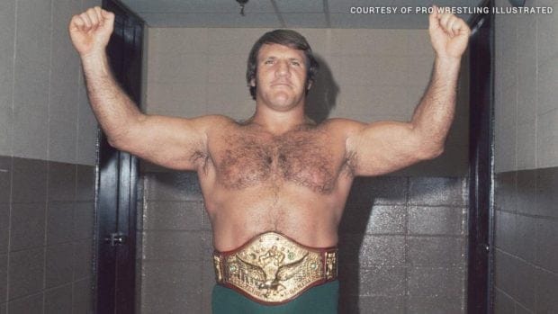 Bruno Sammartino and Freddie Blassie | A Fight Too Real for the Mob Bruno Sammartino in his title belt showing off as victor with arms in the air doing a strong man pose