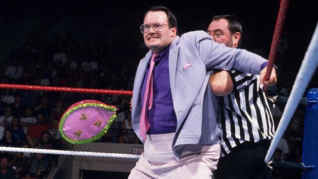 Jim Cornette is No. 2 on our list of greatest managers of all time stands in the ring blocking a referee from interfearing
