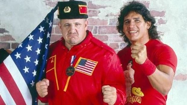 Nikolai Volkoff stories - Nikolai with his Soviet hat, red jacket with the Soviet Union and American flag on it alongside Tito Santana