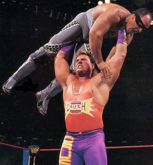 Wrestler Brian Adams holds Repo Man above his head