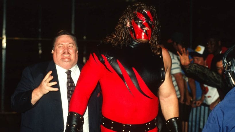 Kane, alongside Paul Bearer, during his WWE debut at the <em>Bad Blood: In Your House pay-per-view in 1997.