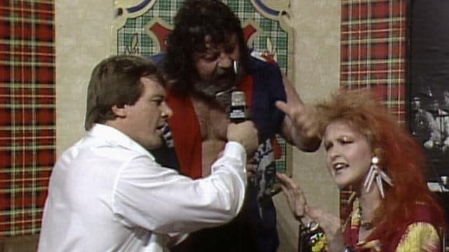 Roddy Piper, 'Captain' Lou Albano and Cyndi Lauper in a Piper's Pit segment in the lead-up to the inaugural WrestleMania.