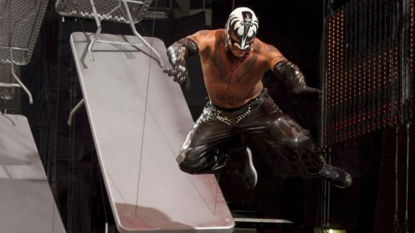 Rey Mysterio must be a fan of glam rock icons Kiss as he has worn the face-painted band's colors on quite a few occasions, most notably at WWE's TLC 2010. Rey's black tights, gloves and gauntlets are studded with rhinestones and his white mask is accentuated with black markings of bassist Gene Simmons Demon makeup.