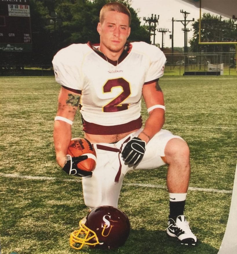 Enzo Amore with short hair during his football playing days.