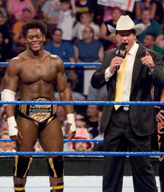 United States Champion Orlando Jordan alongside JBL while part of The Cabinet faction stable in WWE in 2005.