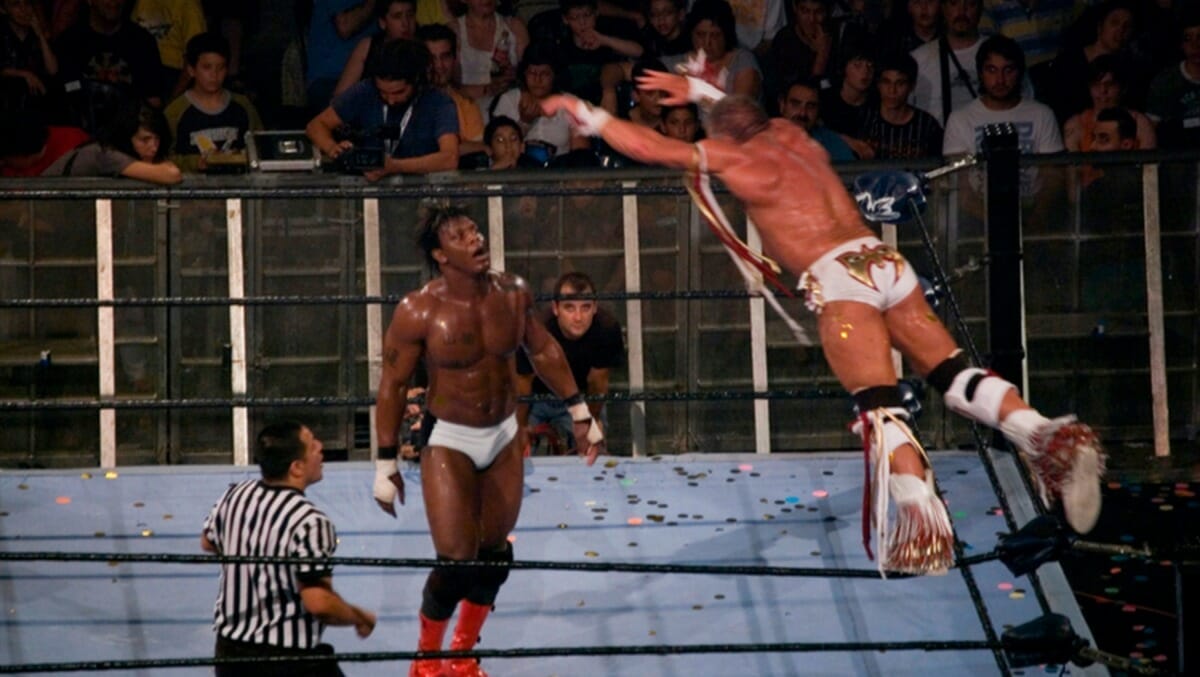 The Ultimate Warrior glides in the air towards his opponent, Orlando Jordan, in what would be Warrior's final-ever match. Nu Wrestling Evolution, Barcelona, Spain, June 25, 2008.