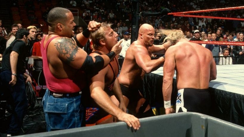 Savio Vega, Owen Hart, Steve Austin, and Triple H brawl outside of the ring at the In Your House: No Way Out of Texas pay-per-view in 1998.