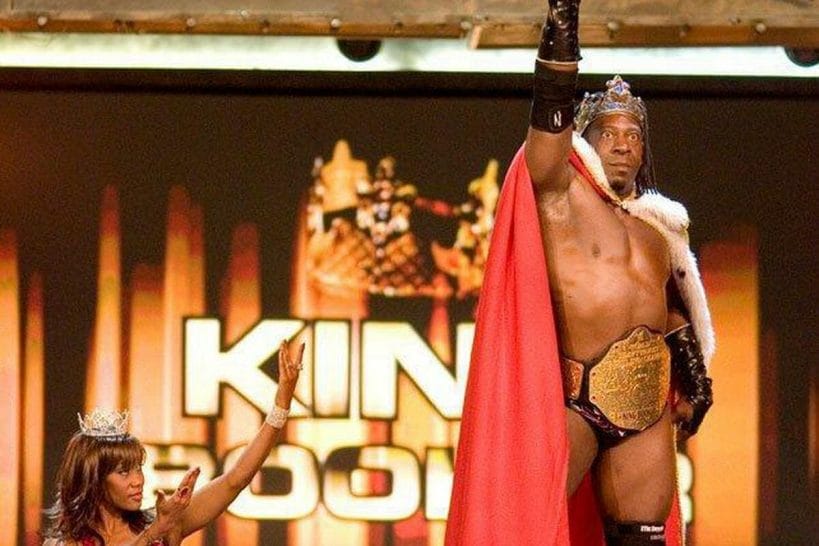 Booker T as WWE World Heavyweight Champion with Sharmelle in 2006.