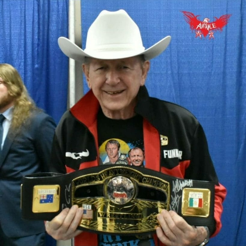 Dory Funk Jr holding the NWA World Heavyweight Championship in 2019. 